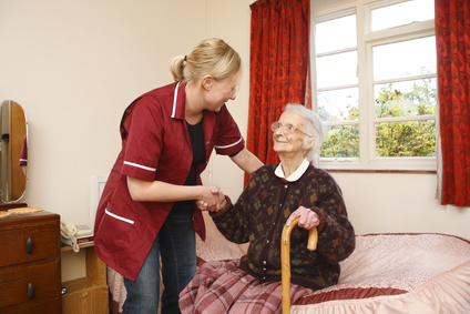 pregnant carer helps her elderly pacient to her feet